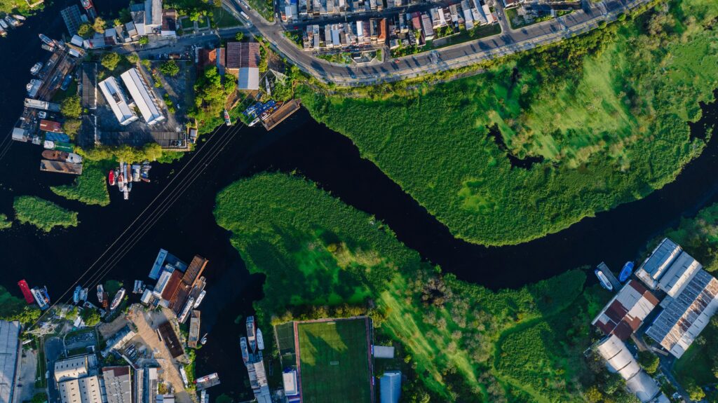 Stunning aerial shot of Glória neighborhood in Manaus, Brazil, featuring winding river and lush greenery.