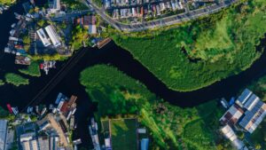 Stunning aerial shot of Glória neighborhood in Manaus, Brazil, featuring winding river and lush greenery.